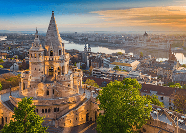 A castle like structure stands out in a city skyline